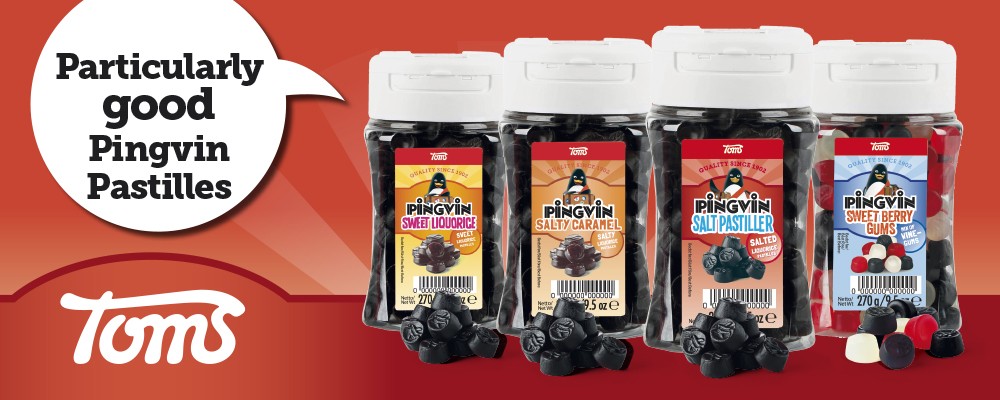 Reklamebanner for Toms Pingvin pastiller med teksten 'Particularly good Pingvin Pastilles'.